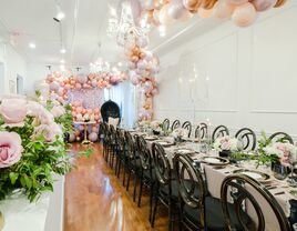 Beautiful intimate rehearsal dinner space with balloons and florals