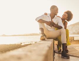 Couple hugging and smiling at each other.