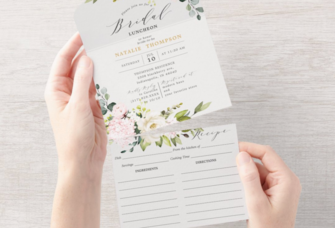 Woman holding floral bridal shower recipe card