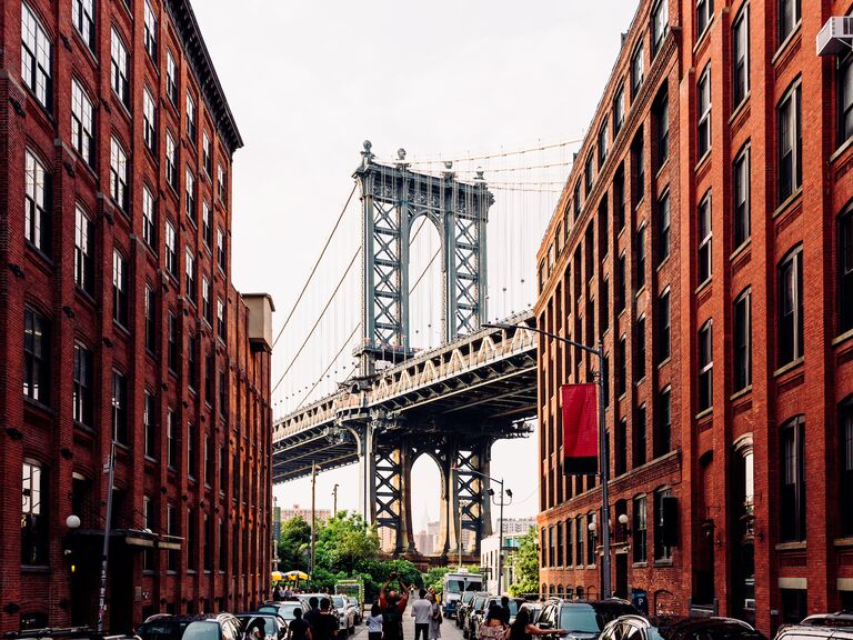 Street in Dumbo Brooklyn with Manhattan Bridge between buildings, New York