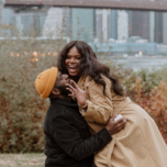 Man and woman hugging after proposal during the winter