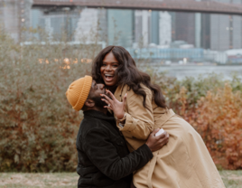 Man and woman hugging after proposal during the winter