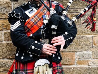 Man in uniform playing the bagpipes