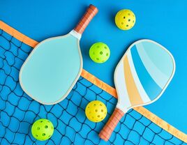 Two pickleball bats on a court