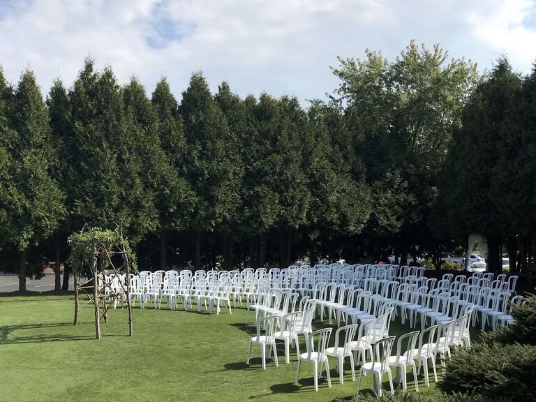 Golf course ceremony site with a wooden arch