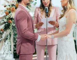 Couple getting married by officiant at the altar