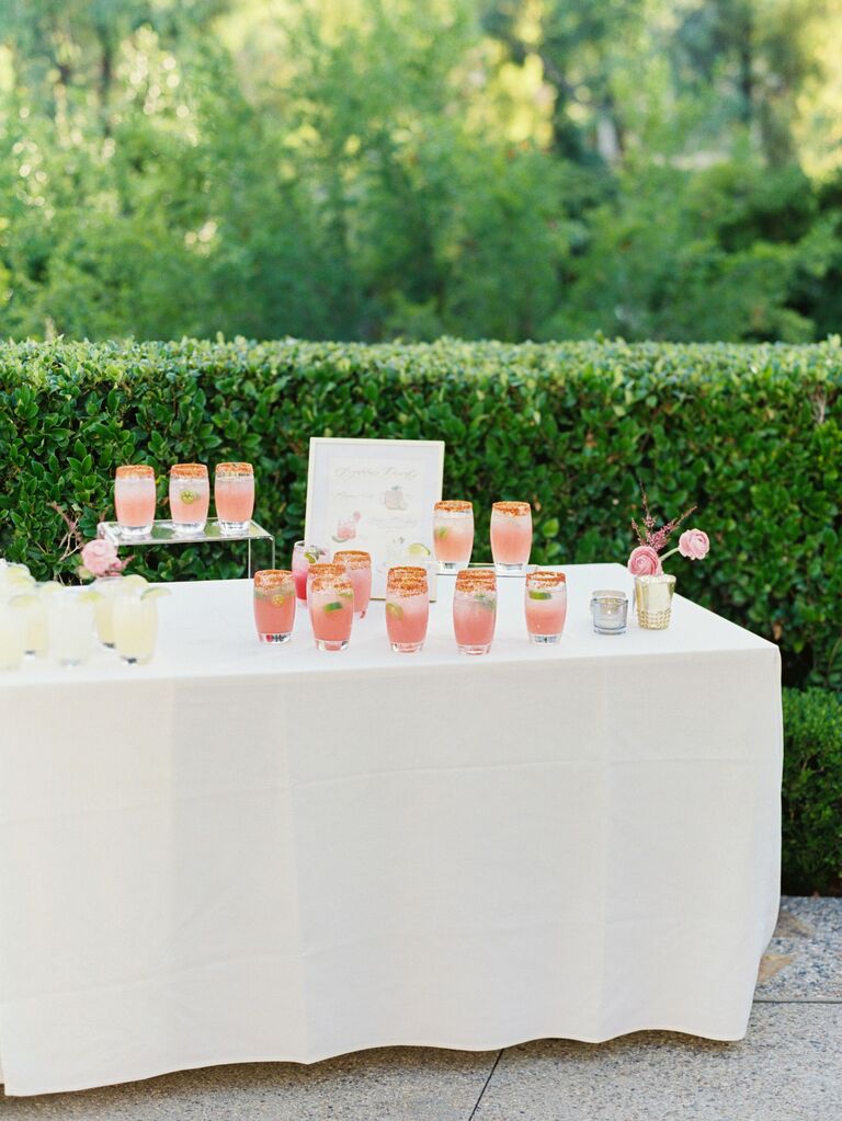 table with pink margaritas and custom wedding drink sign