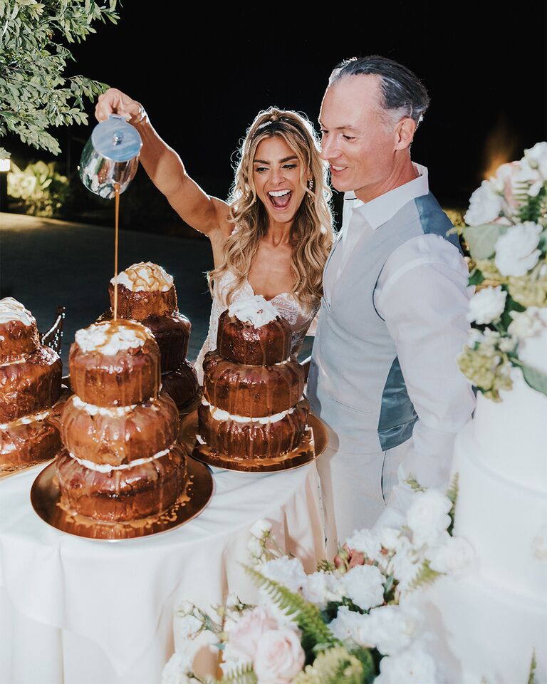 Jessica Hirsch and Brian Coogan enjoying a cinnamon roll cake on their wedding day