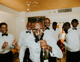 Groom posing with groomsmen on wedding day