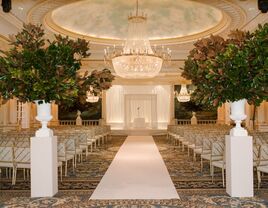 Inside ceremony space with a grand crystal chandelier and stage