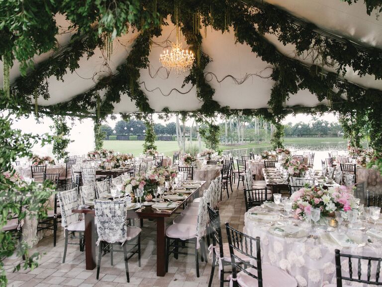 Garland-draped ceiling of outdoor wedding tent