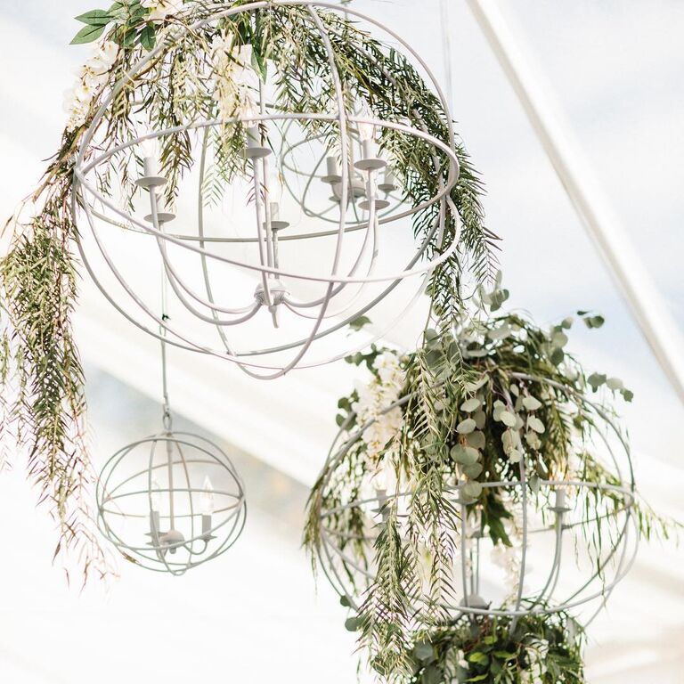 Hanging lights decorated with greenery at Zach and Julie Ertz's wedding