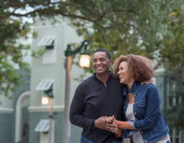 Couple smiling while walking around on a date in Orlando 