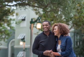Couple smiling while walking around on a date in Orlando 