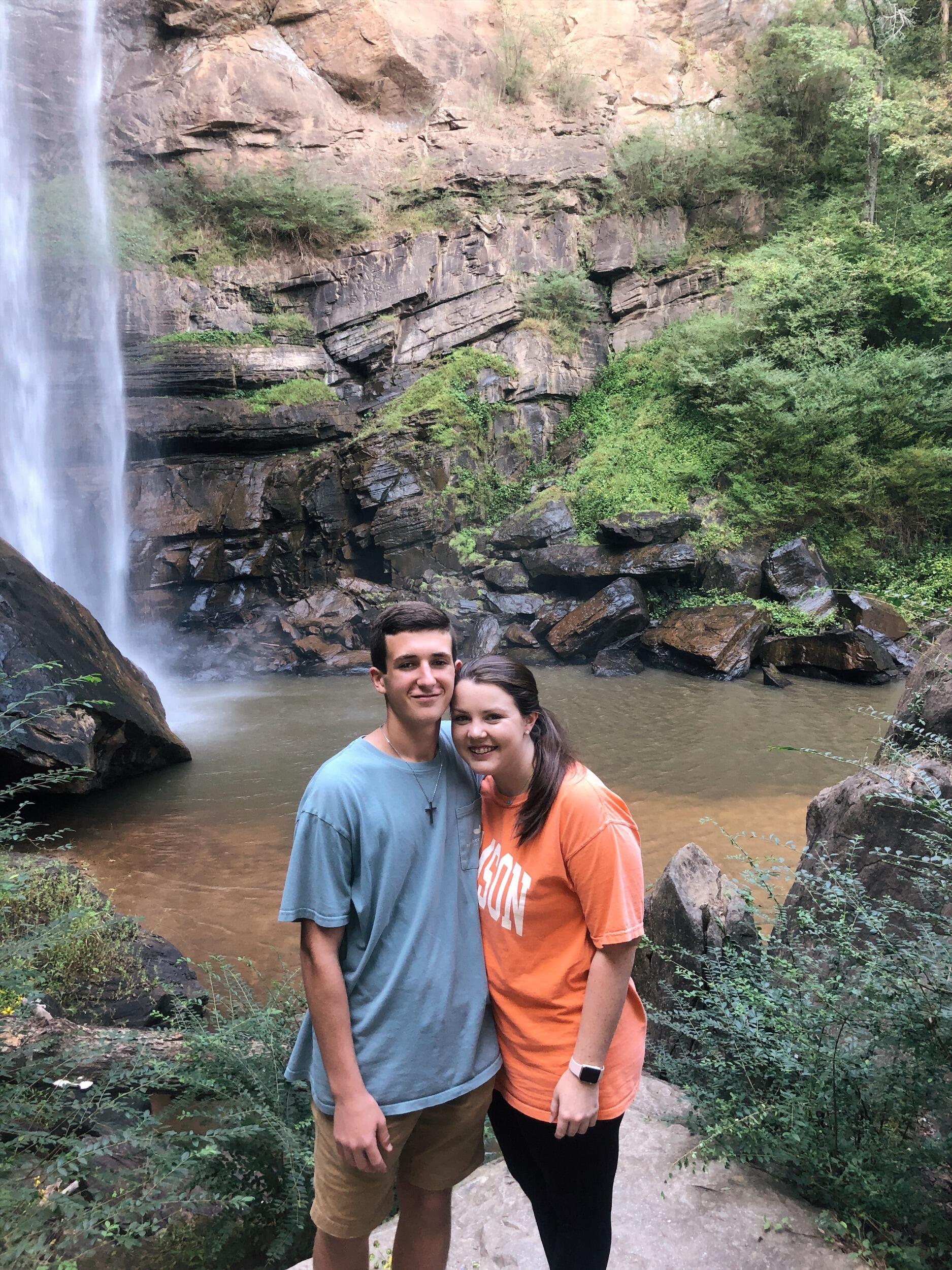 Tyler and Sandra met at Chick-fil-A! Through their love of serving the Lord's chicken, they developed a love for each other! On their first date, Tyler and Sandra went to Toccoa Falls to see a beautiful waterfall! While viewing the falls; a wedding happened right behind them where they joked about that being them one day! 