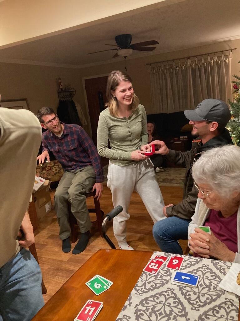 Thean proposes in front of friends & family. Grace says "yes!"