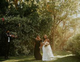 Bride being walked down the aisle by woman