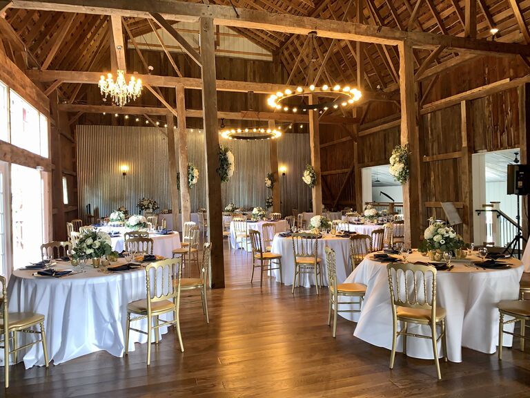 Inside the intimate barn reception space with a rustic aesthetic