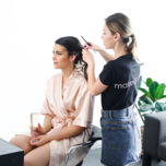 Bride getting hair styled on wedding day