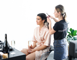 Bride getting hair styled on wedding day