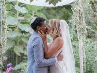 Couple kiss at wedding ceremony