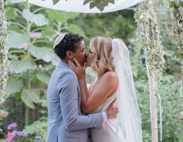 Couple kiss at wedding ceremony