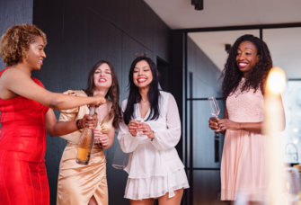 four women celebrating with champagne at a bridal shower