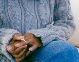 woman anxiously holding engagement ring