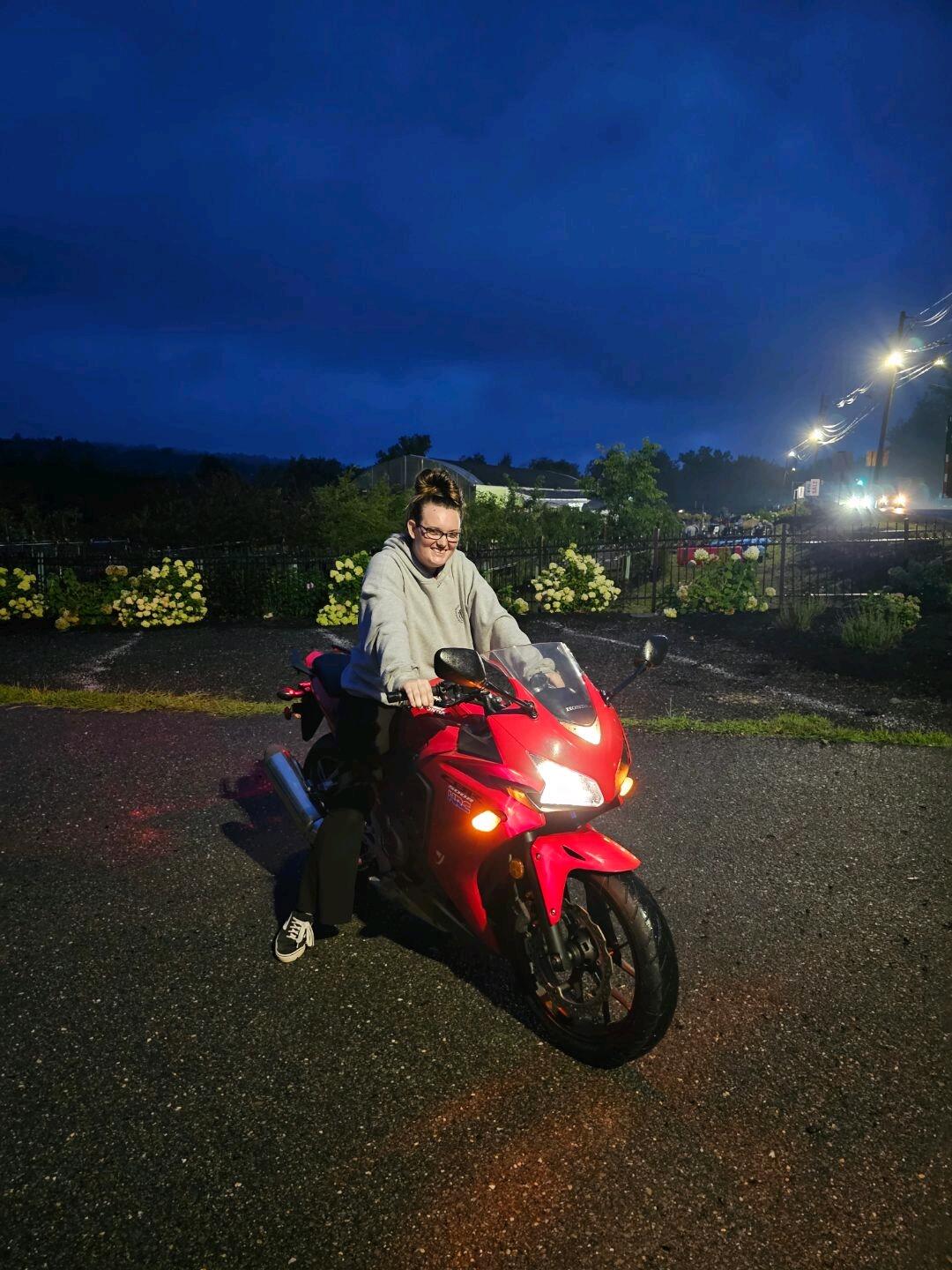 EJ teaches Kali how to ride a motorcycle. 