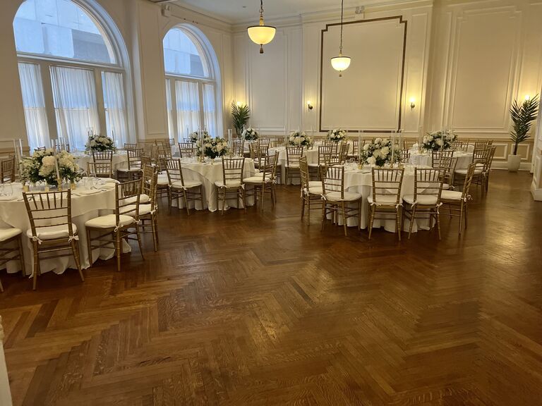 Inside grand ballroom with large windows and wooden flooring