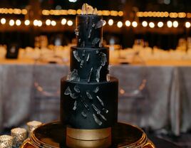 Three-tier black wedding cake. 