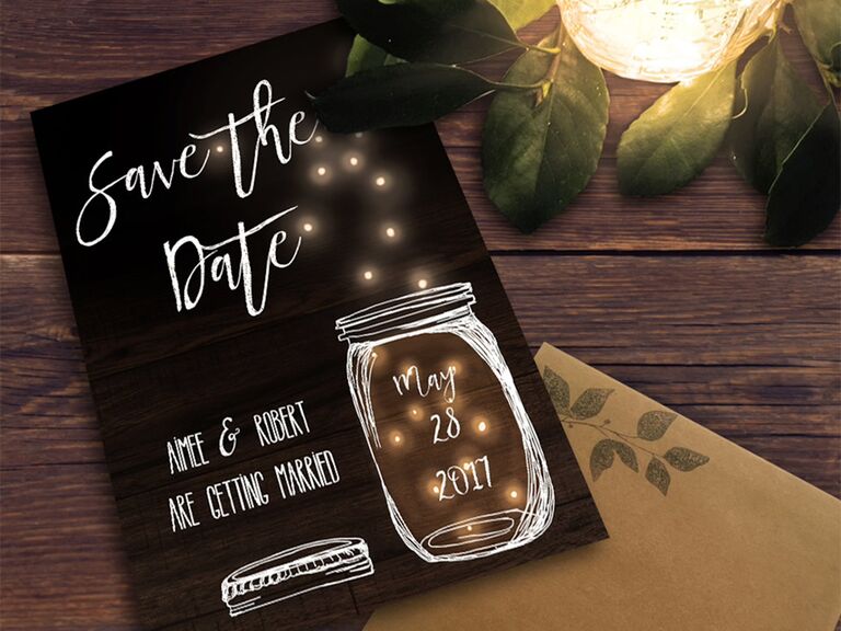 Mason jar with fairy light design, 'Save the Date' in white calligraphy on black background
