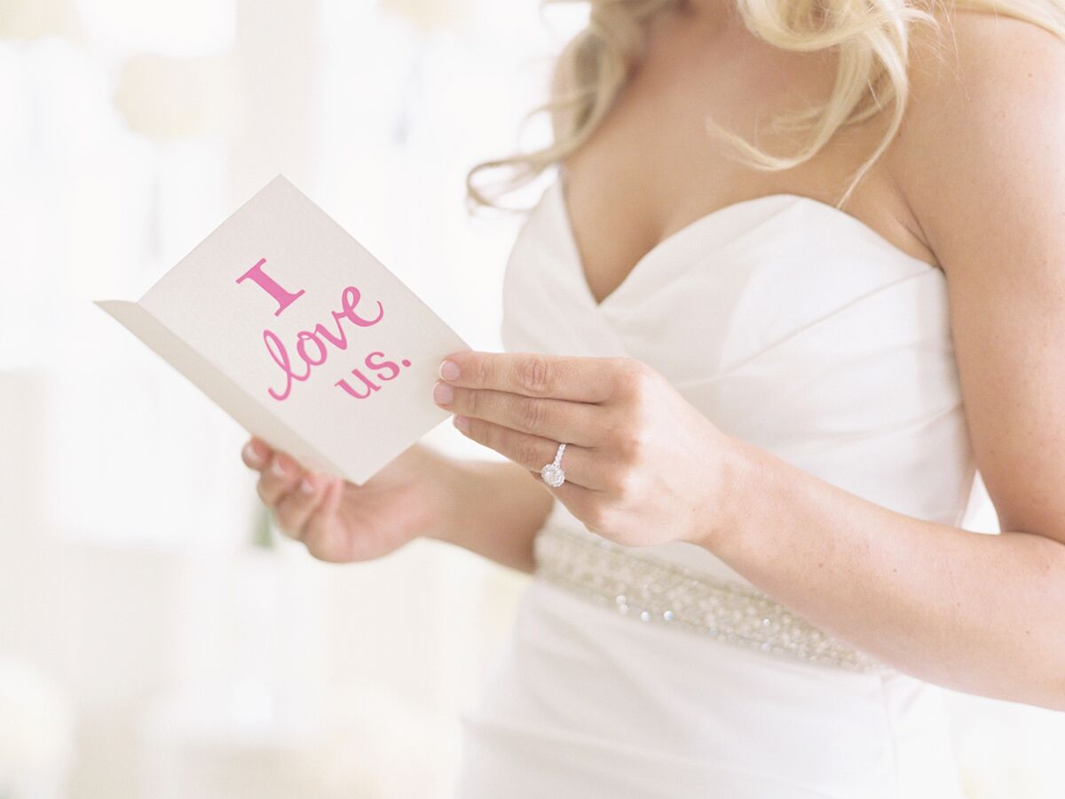 Bride reads a card on her wedding day