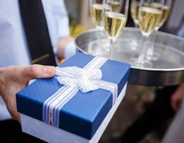 wrapped present near champagne glasses