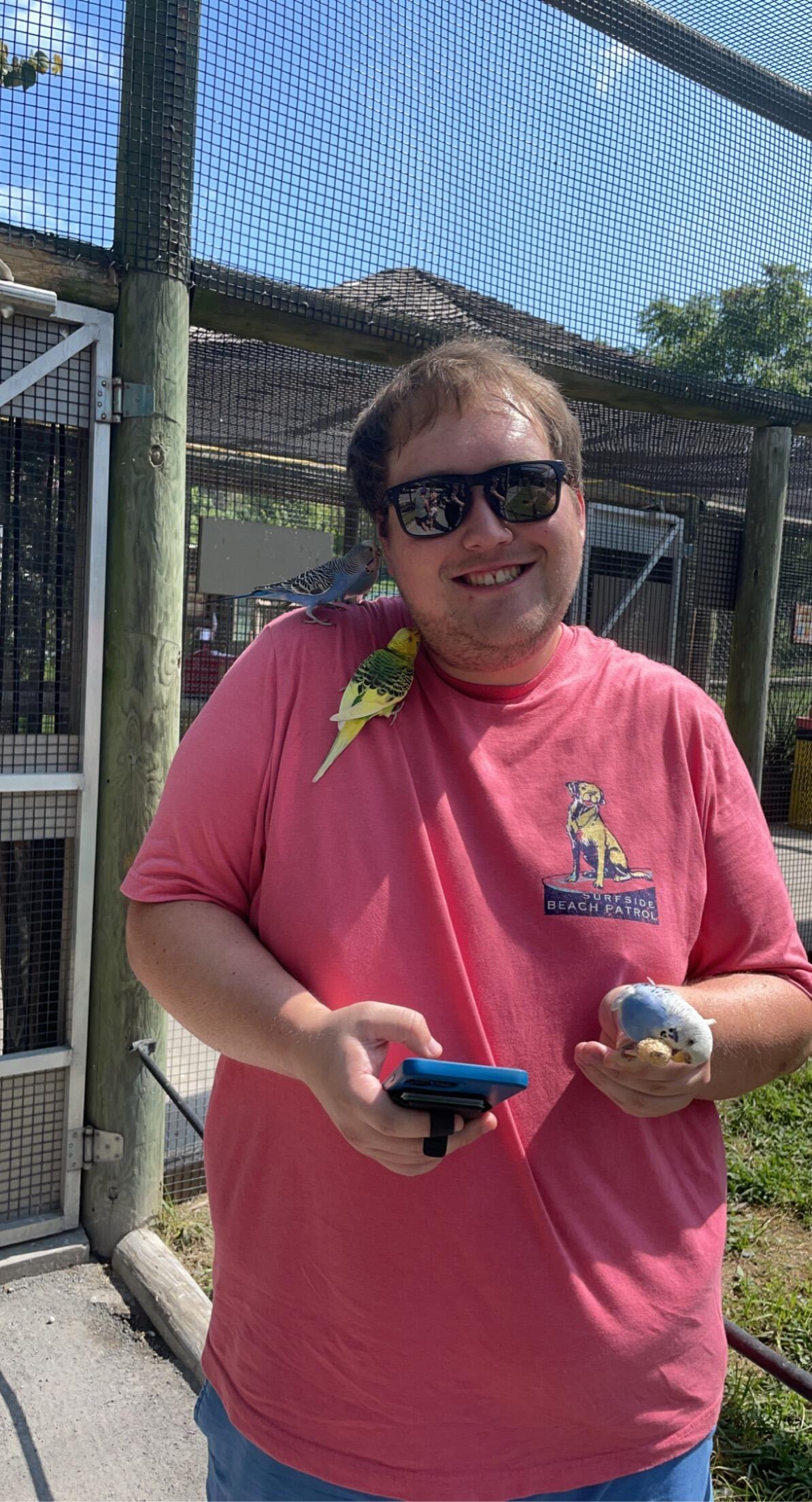 Brett drove through a zoo to feed different animals with a feed bucket. Then they fed birds on sticks! The birds loved the sweat on Brett's head! 