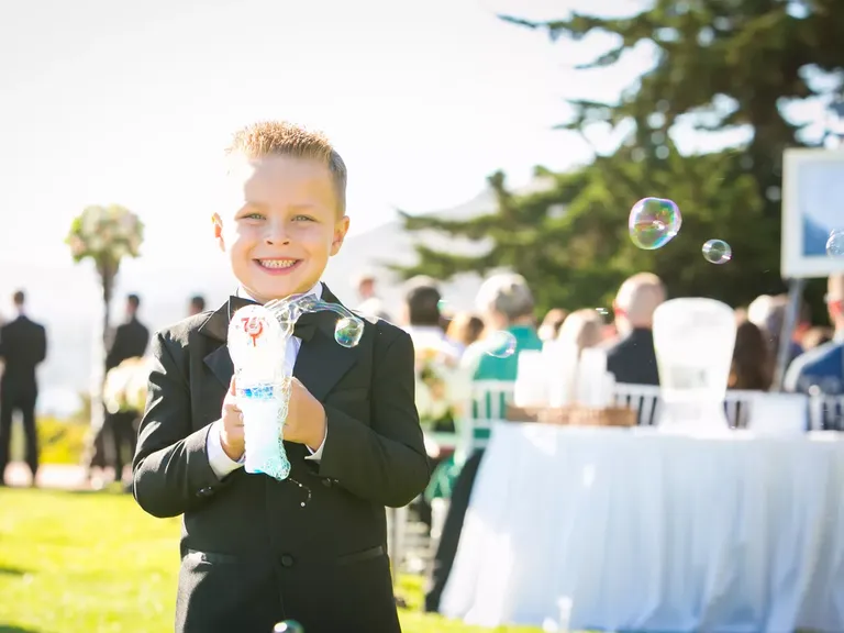 Ring Bearer Blowing Bubbles at Ceremony