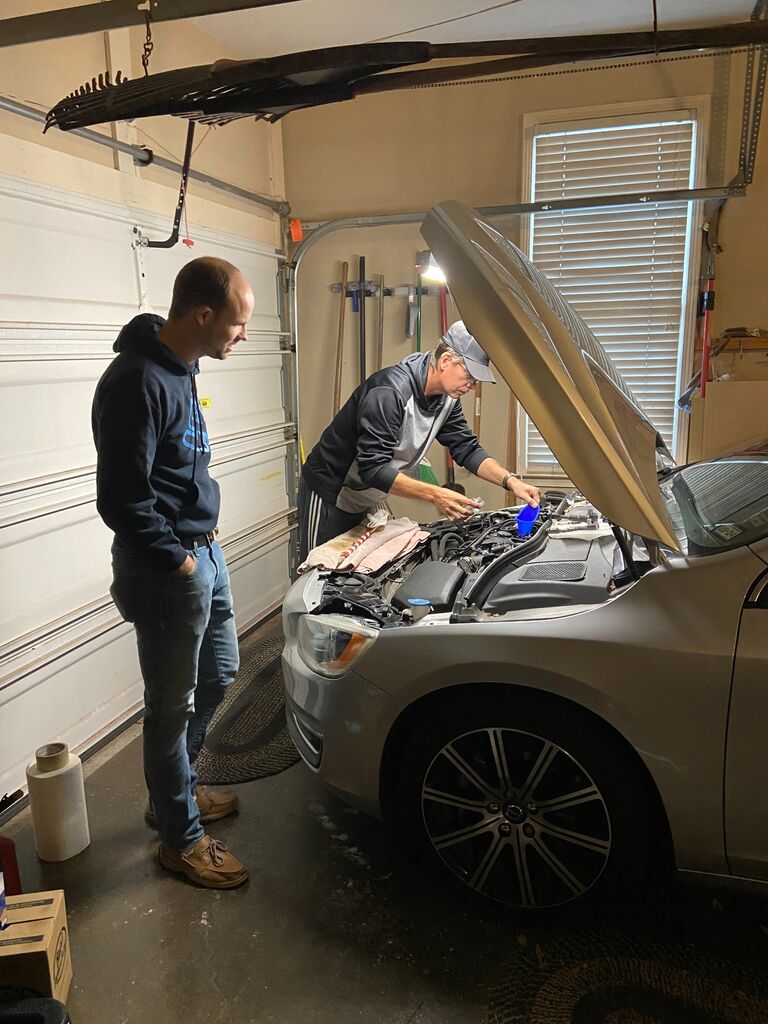 Dad and Chris connecting over cars, and helping Chris out with some repairs.