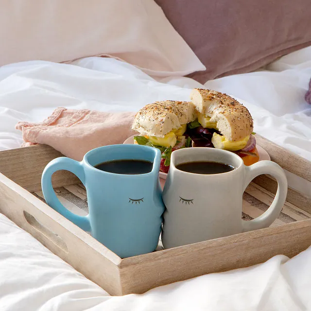 Cute matching kissing mugs on a breakfast tray