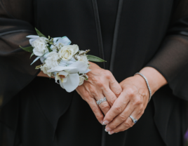 Close-up of mother-in-law's hands with blue floral corsage 