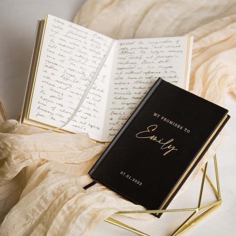 custom vow book with black hardcover and gold lettering