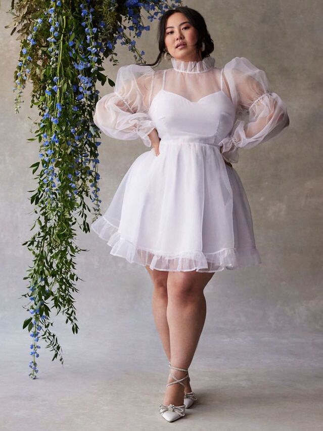 Short plus sized wedding dress by ELOQUII. 