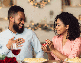 Woman proposing to a man at dinner. 