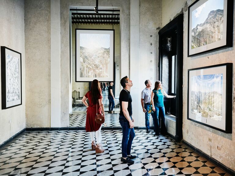 People admiring artwork in museum during vacation in Mexico