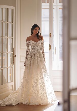 Katniss - semi-translucent tulle dress embellished with floral accents. Detailed corset with heart-shaped neckline is complemented by tulle embroidered sleeves.