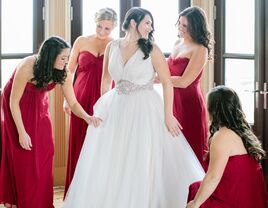 Bridesmaids helping bride before wedding 