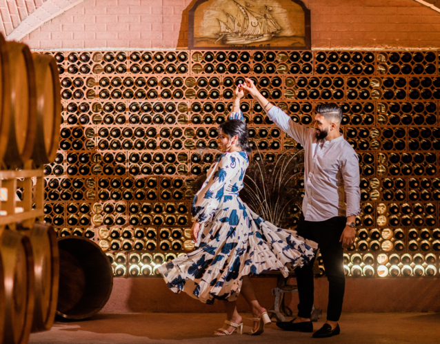 Couple dancing in wine cellar engagement party venue