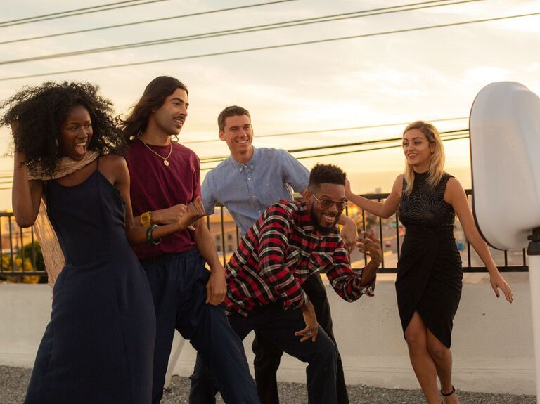 Guests dancing in front of an open-air photo booth