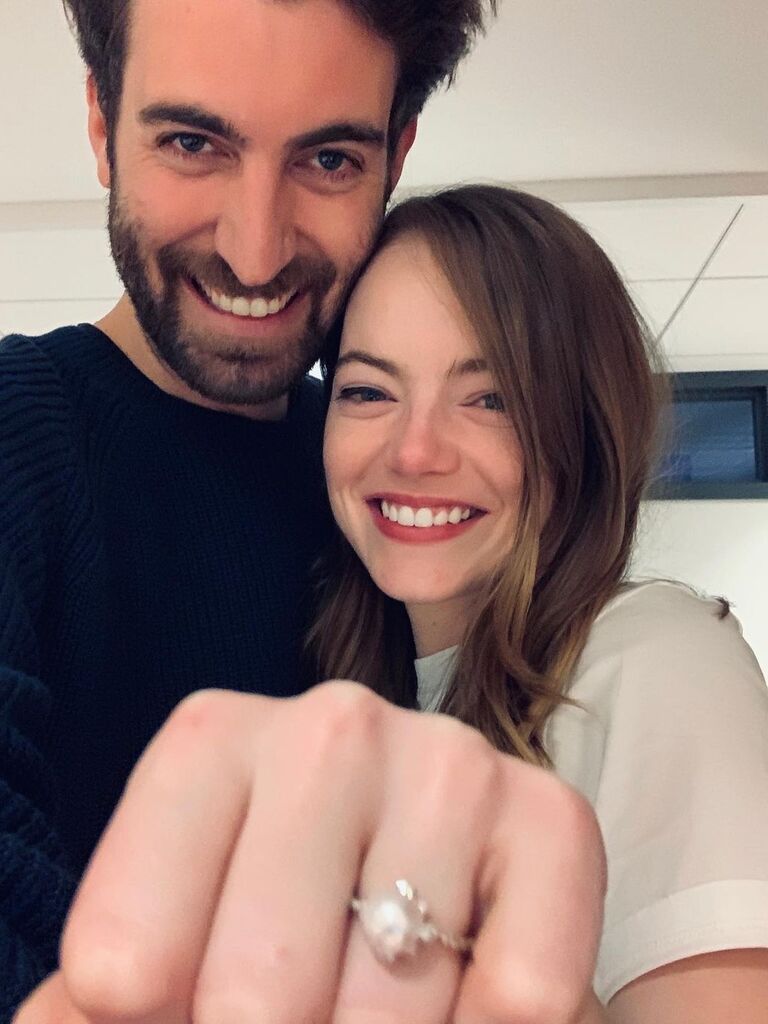 Emma Stone and Dave McCary showing off her engagement ring 