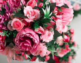 A spring-time bouquet of pink and fuchsia artificial flowers.