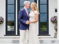 Bride and groom holding hands looking at each other